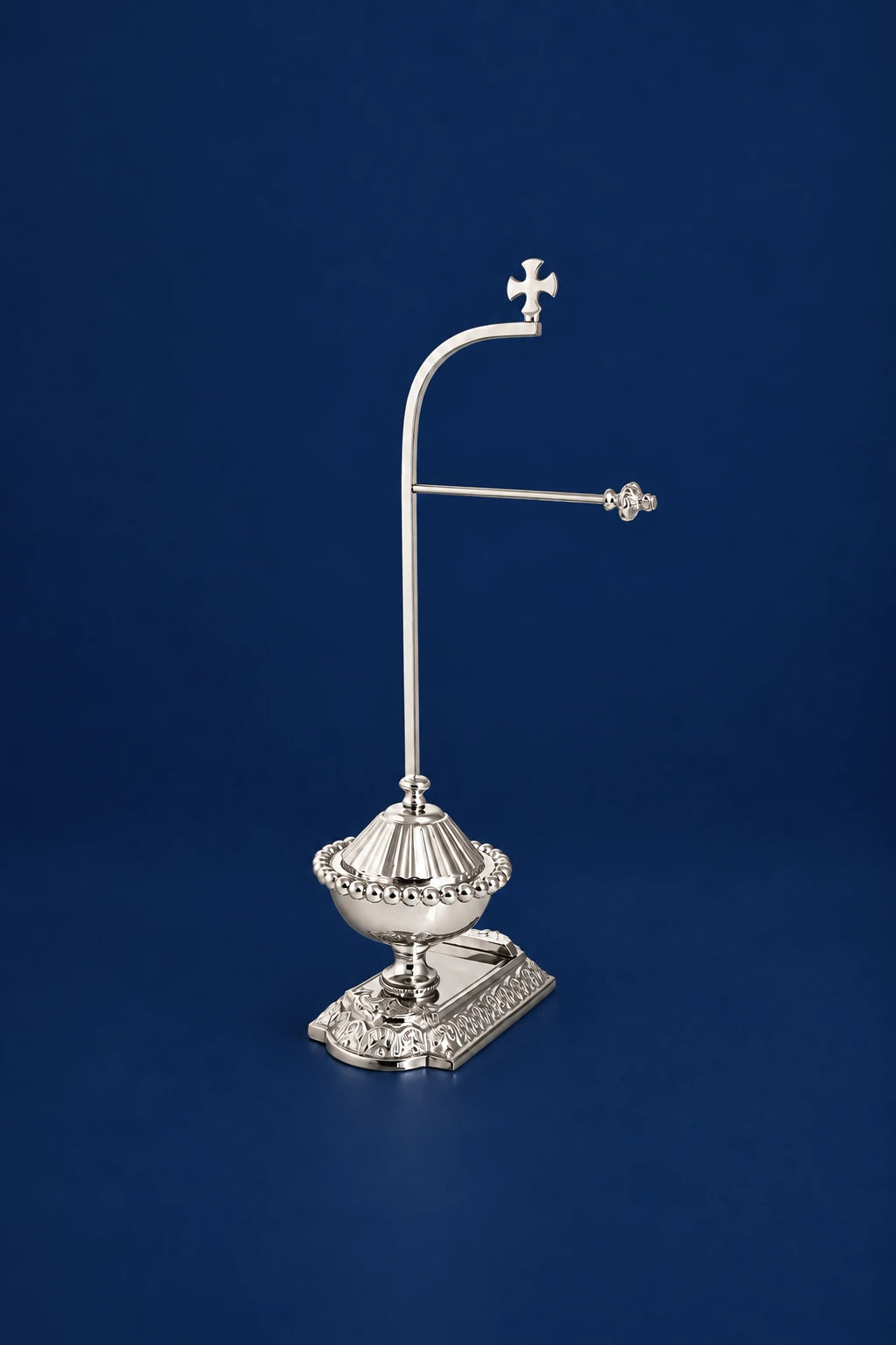 Nickel-plated brass purificator holder, 15 in (38 cm), full view with cross finial and ornate base