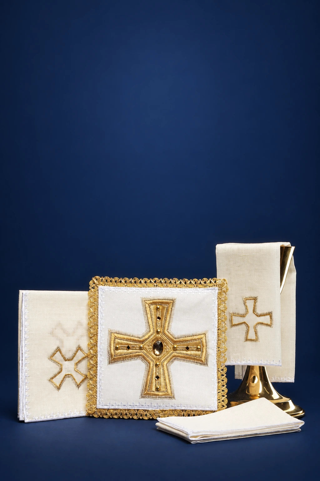 Altar linen set with gold embroidered crosses and central jeweled cross panel, shown folded