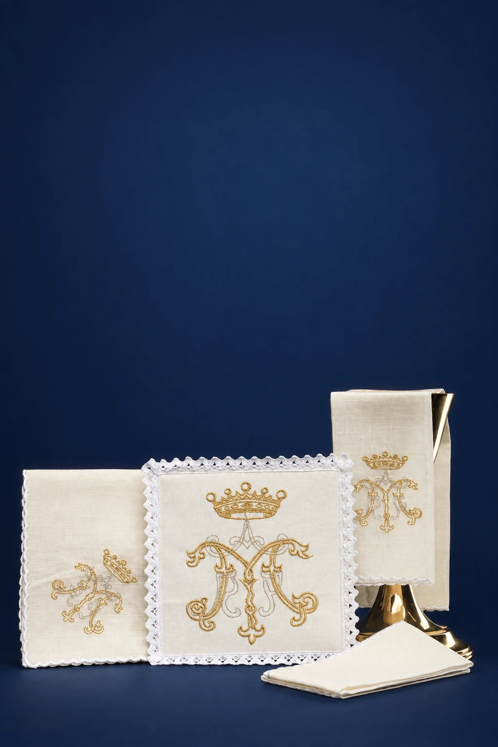 Altar linen set in linen with gold Marian embroidery, including folded cloths and corporal with lace trim