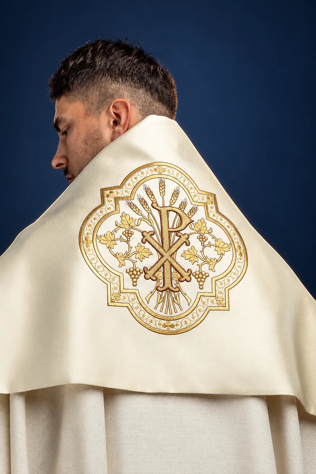 Back view of an ecru humeral veil with large embroidered PAX motif and wheat and grape detailing