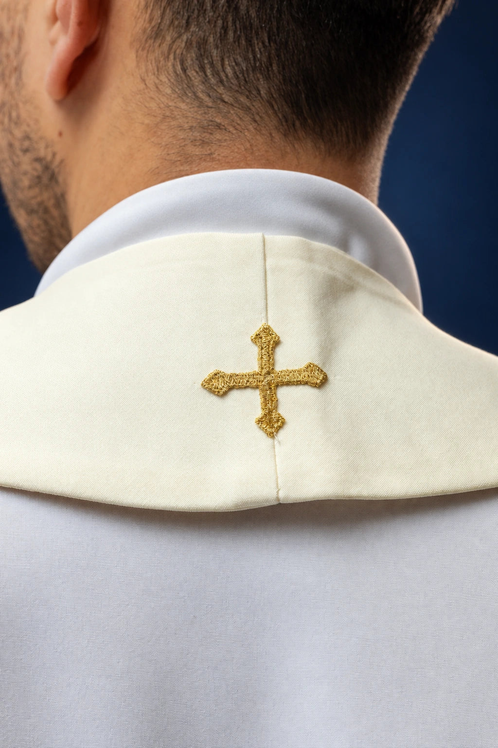 Back view of the ecru stole collar with a small gold cross embroidery at the center