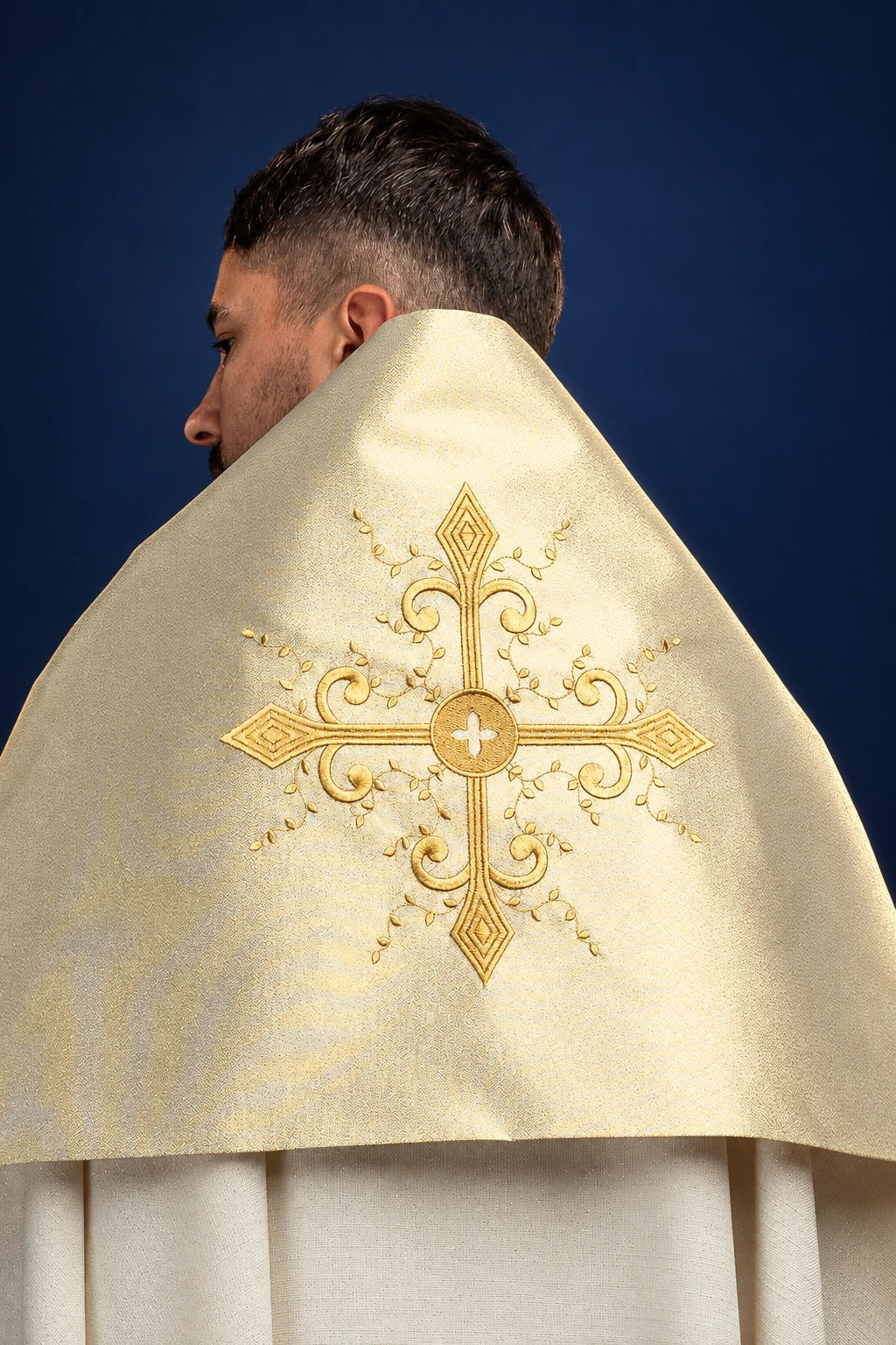 Back view of gold humeral veil with embroidered cross motif at center