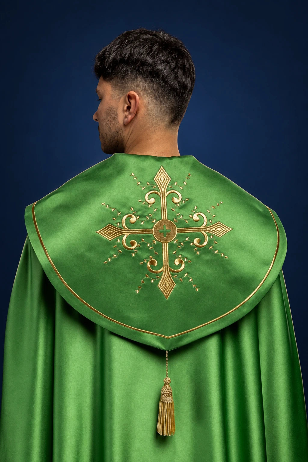 Back view of a green cope with wide embroidered orphrey and large cross motif on the hood