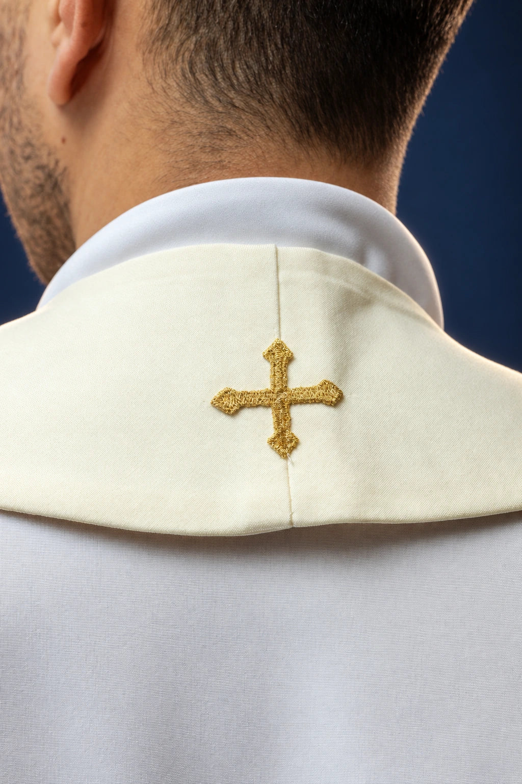 Back view of a priest stole with a gold cross embroidered at the center neckline