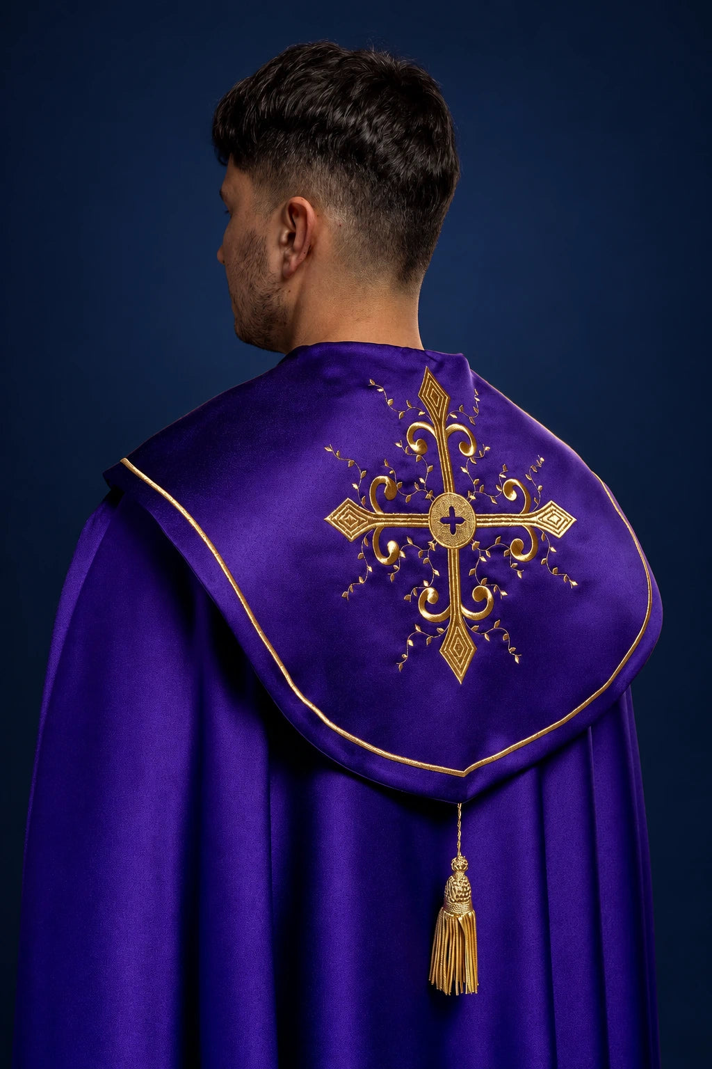 Back view of a purple cope with gold cross embroidery and tassel trim