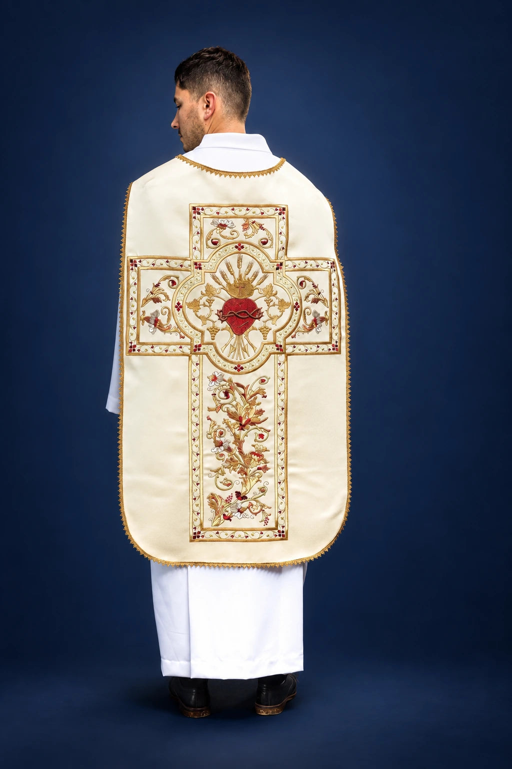 Back view of a Roman chasuble with gold trim and embroidered Sacred Heart cross design on the back.