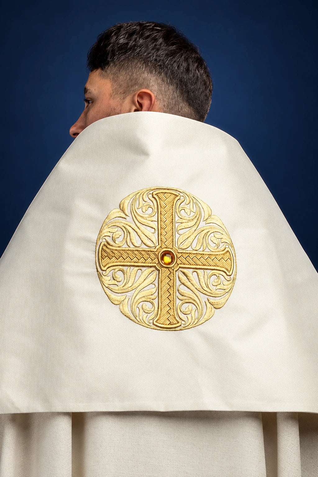 Back view of white humeral veil with round gold embroidered cross and center stone on the shoulder