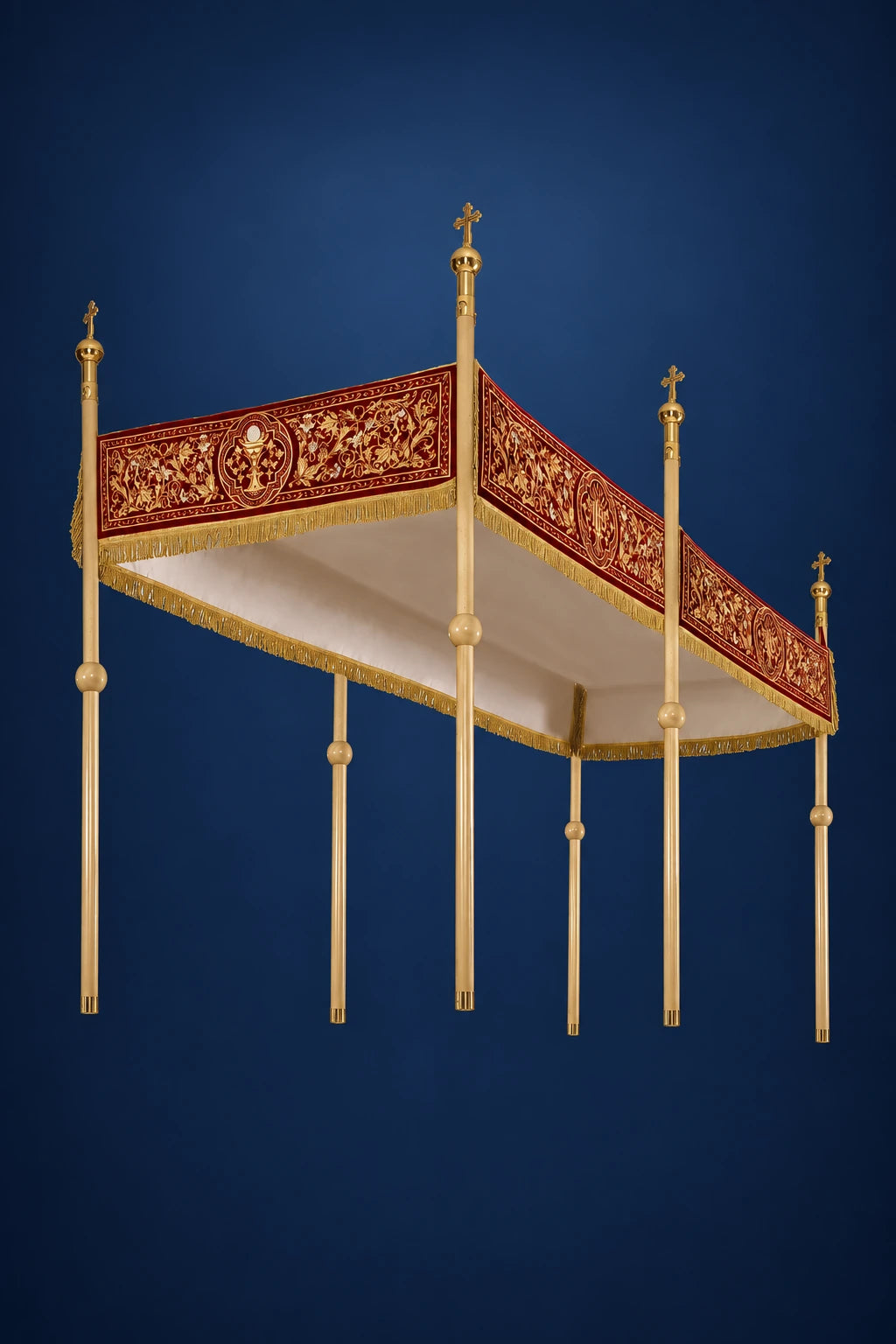 Burgundy processional canopy with gold embroidered IHS border and four gold poles, angled view