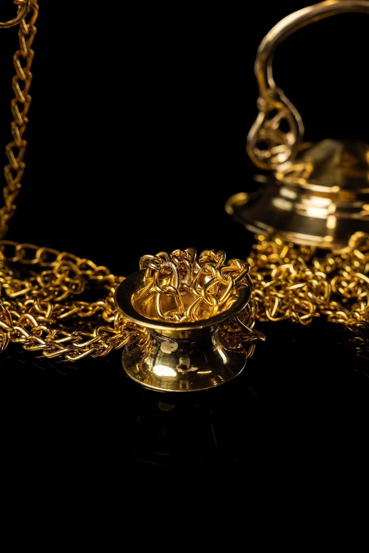 Gold church thurible chain and side attachment close-up