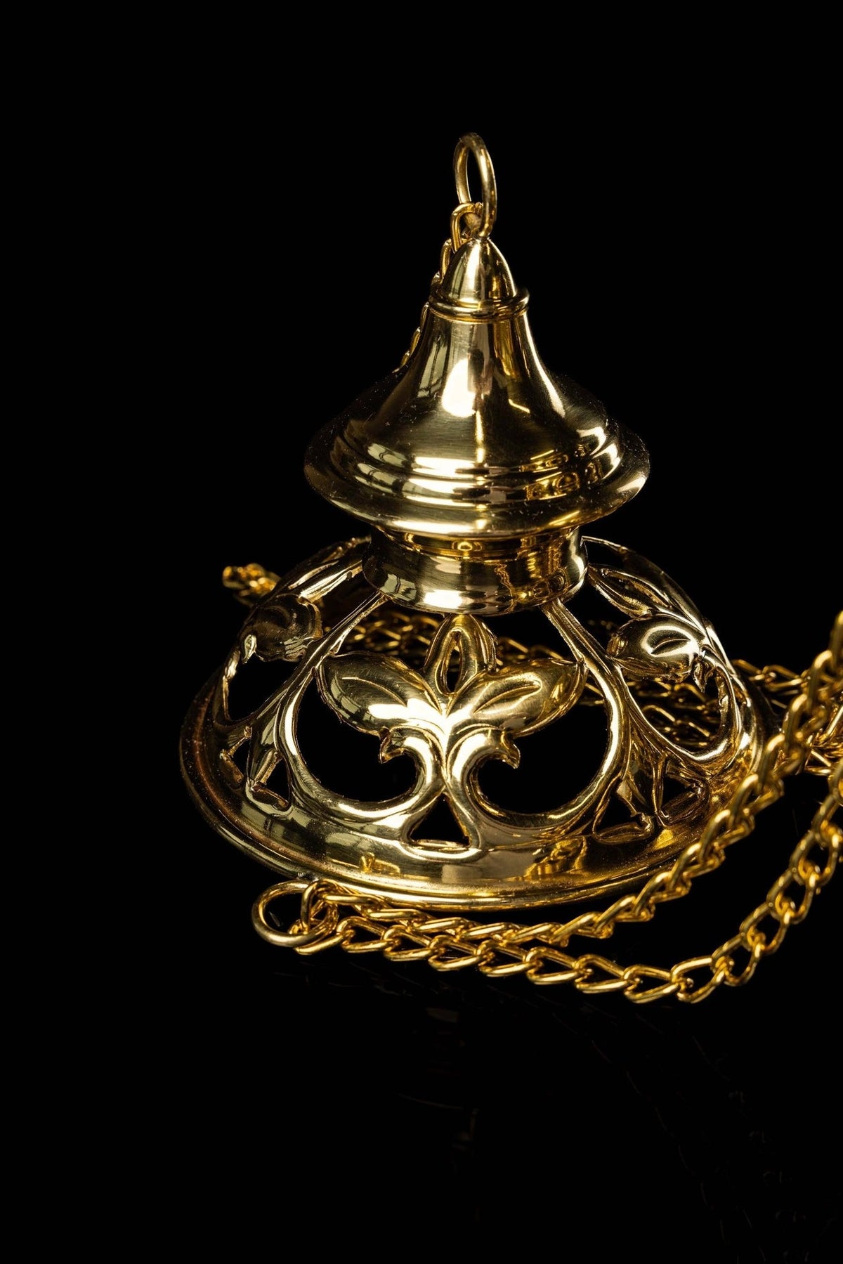 Brass thurible close-up of openwork scrolls, chains and pedestal base