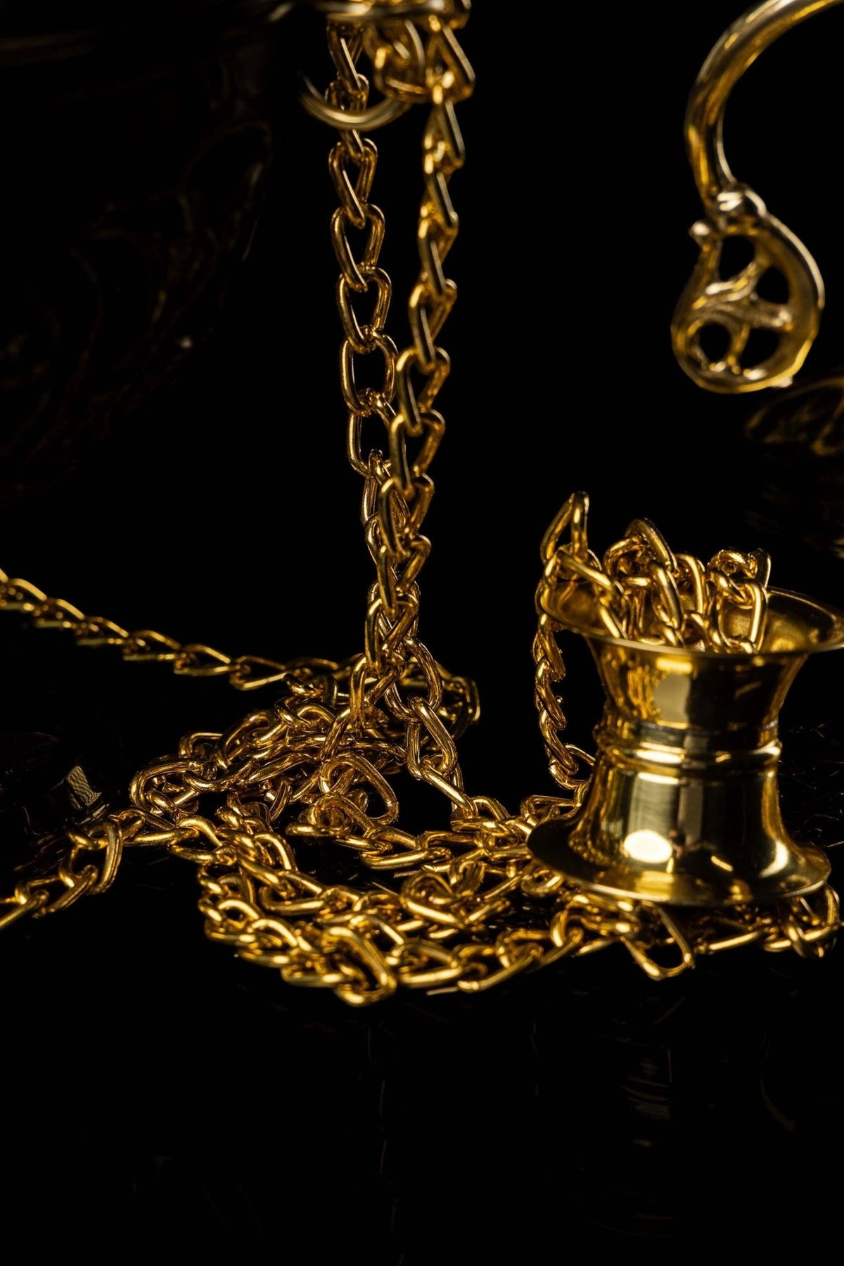 Brass thurible lid close-up with smooth conical top and suspension ring