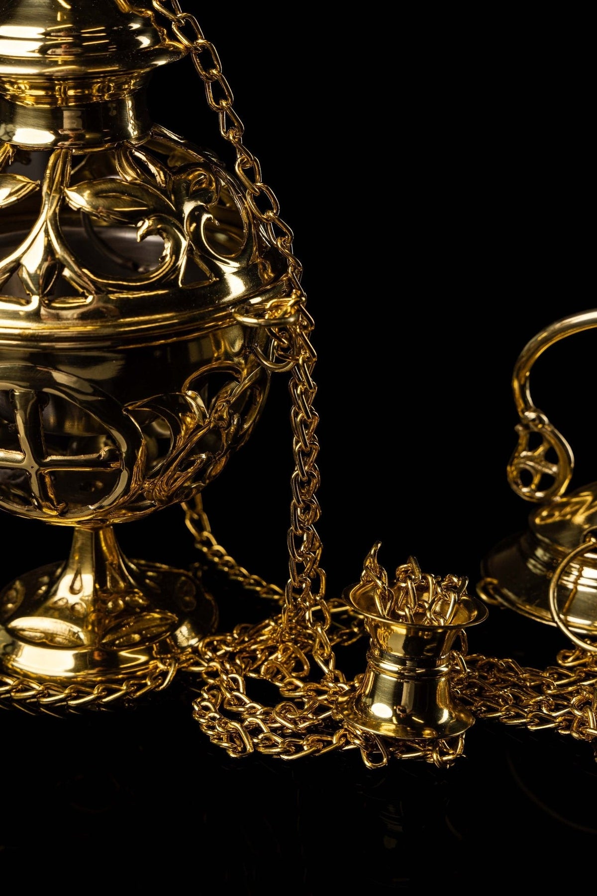 Brass thurible chain and incense cup close-up