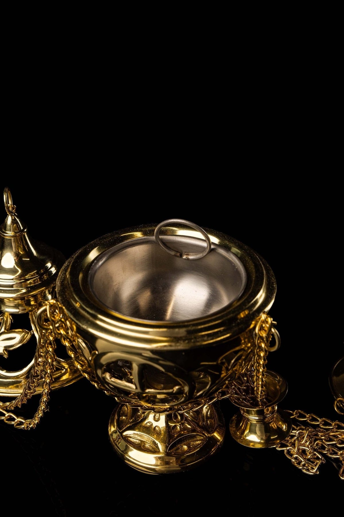 Brass thurible suspension handle close-up with decorative openwork fittings