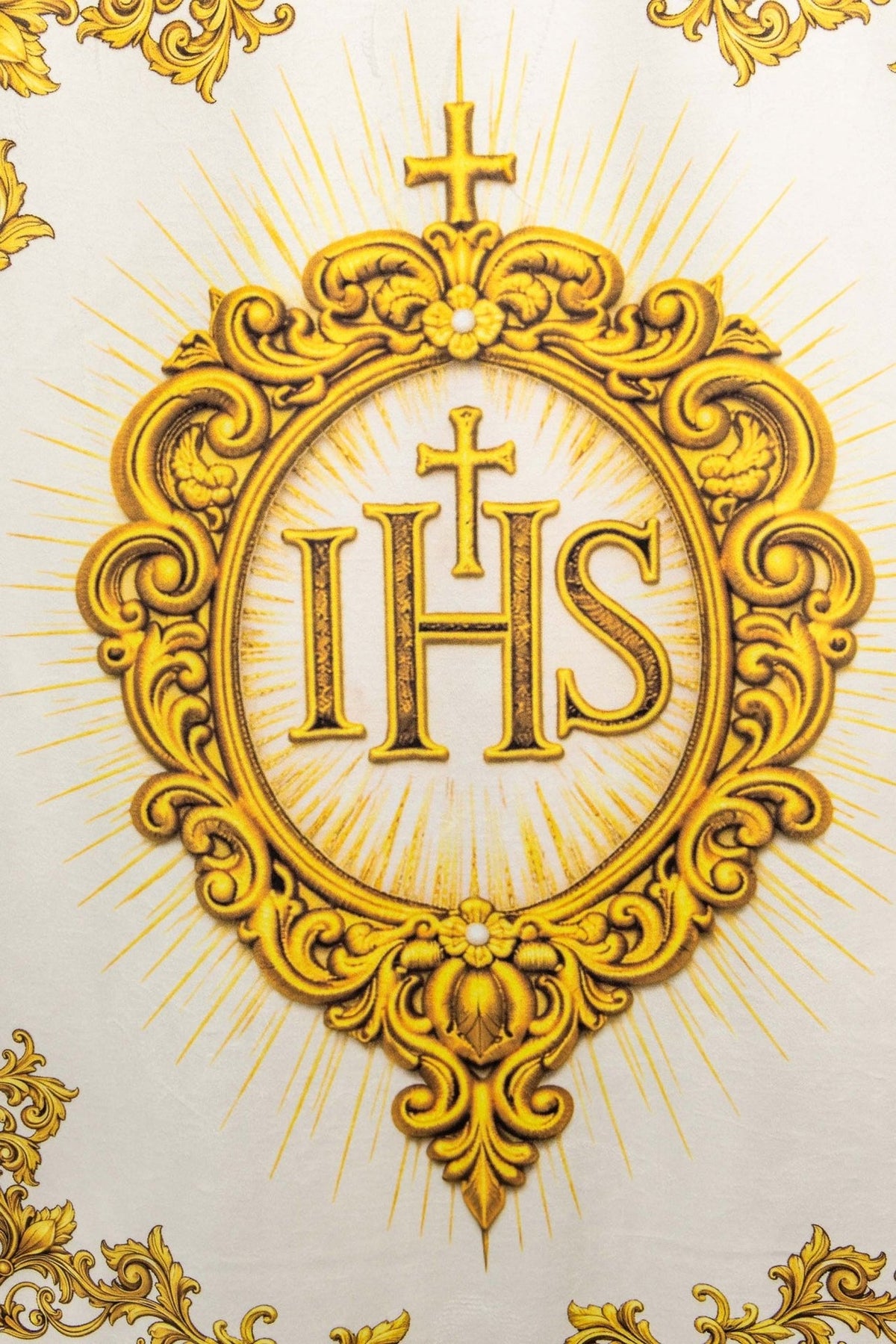 Church banner close-up of gold IHS emblem with radiating lines