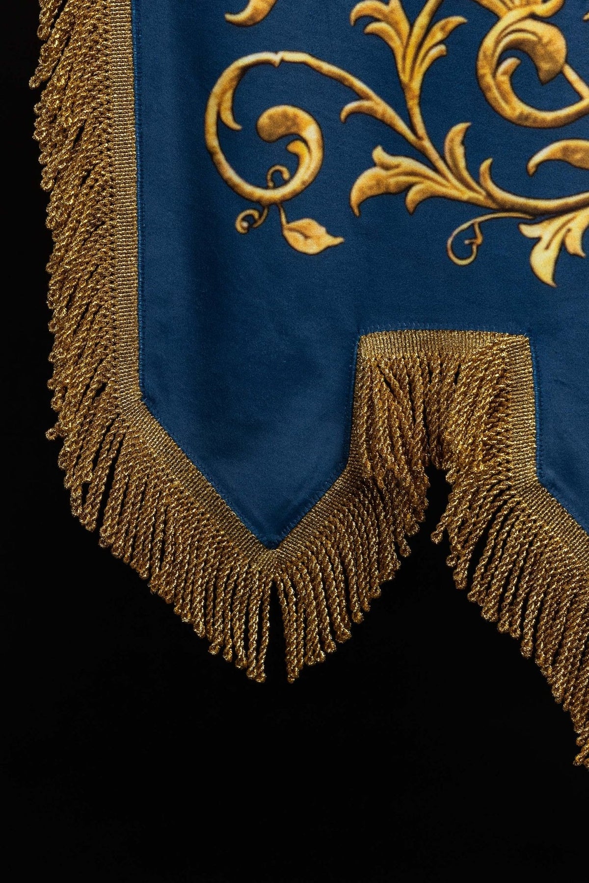 Church banner close-up of twisted gold fringe on blue fabric
