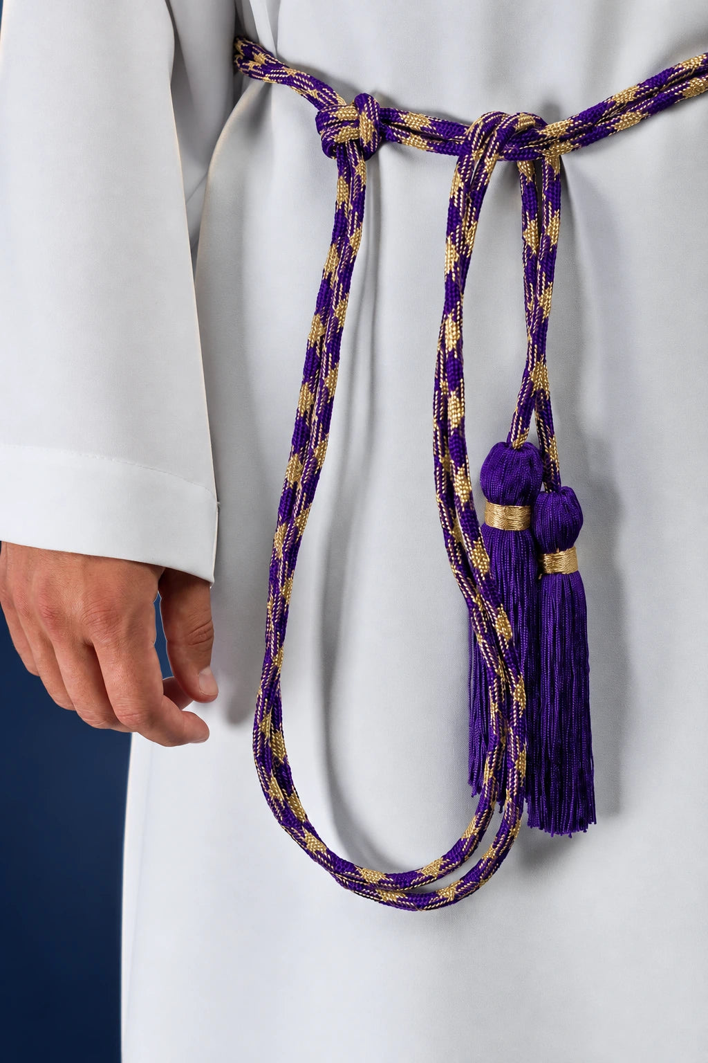 Purple and Gold Liturgical Cincture worn over a white alb, with braided cord and purple tassel