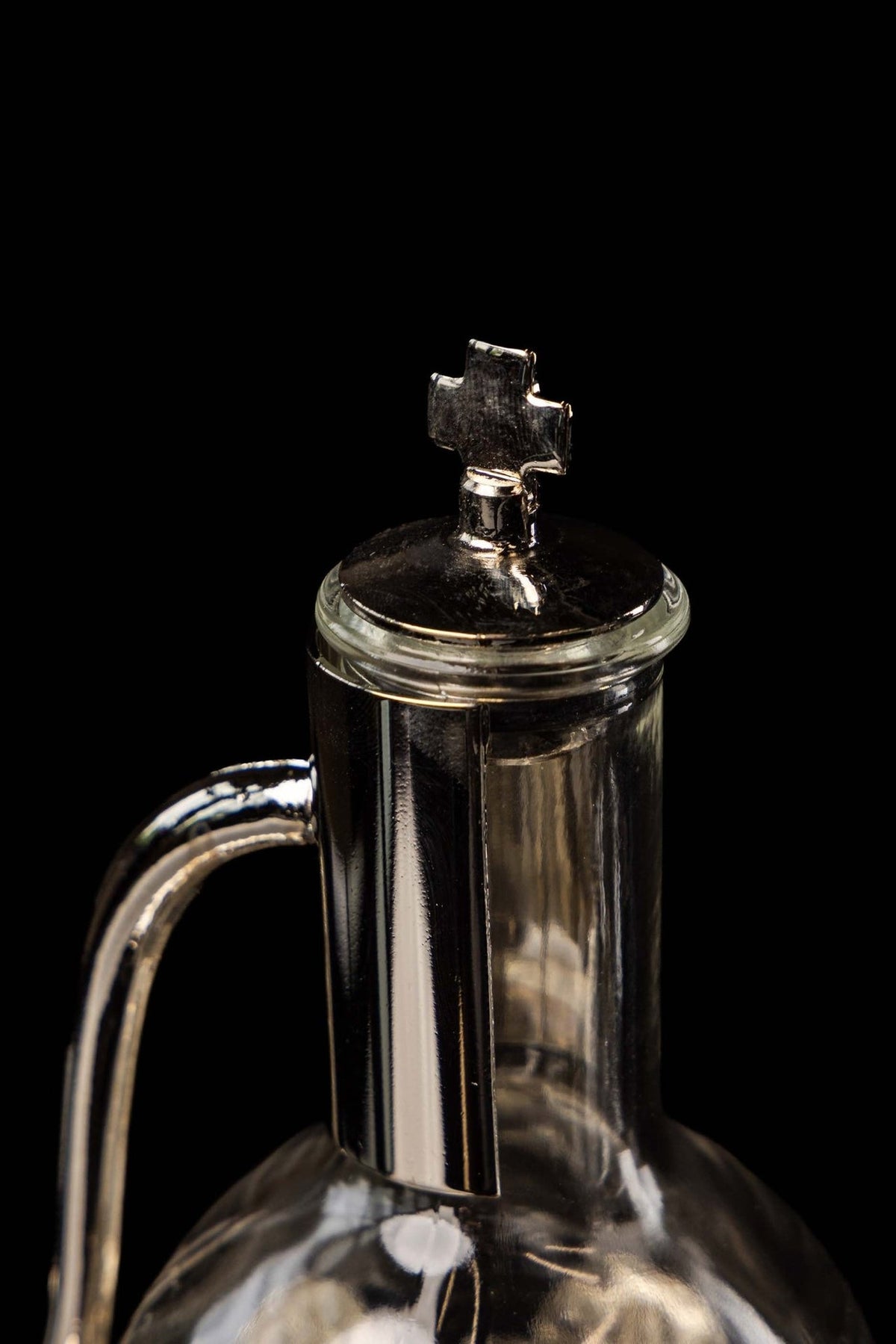 Liturgical cruet with cross finial, lid and curved handle