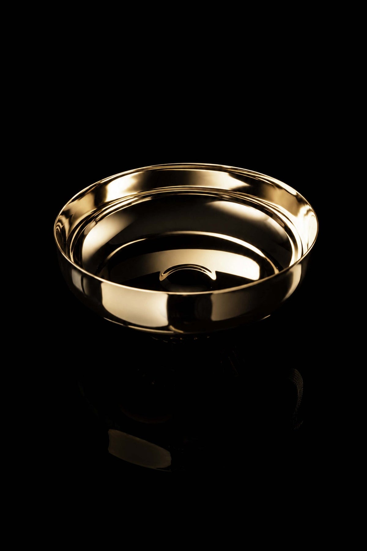 Gold-plated brass paten angled view showing the smooth interior and raised rim
