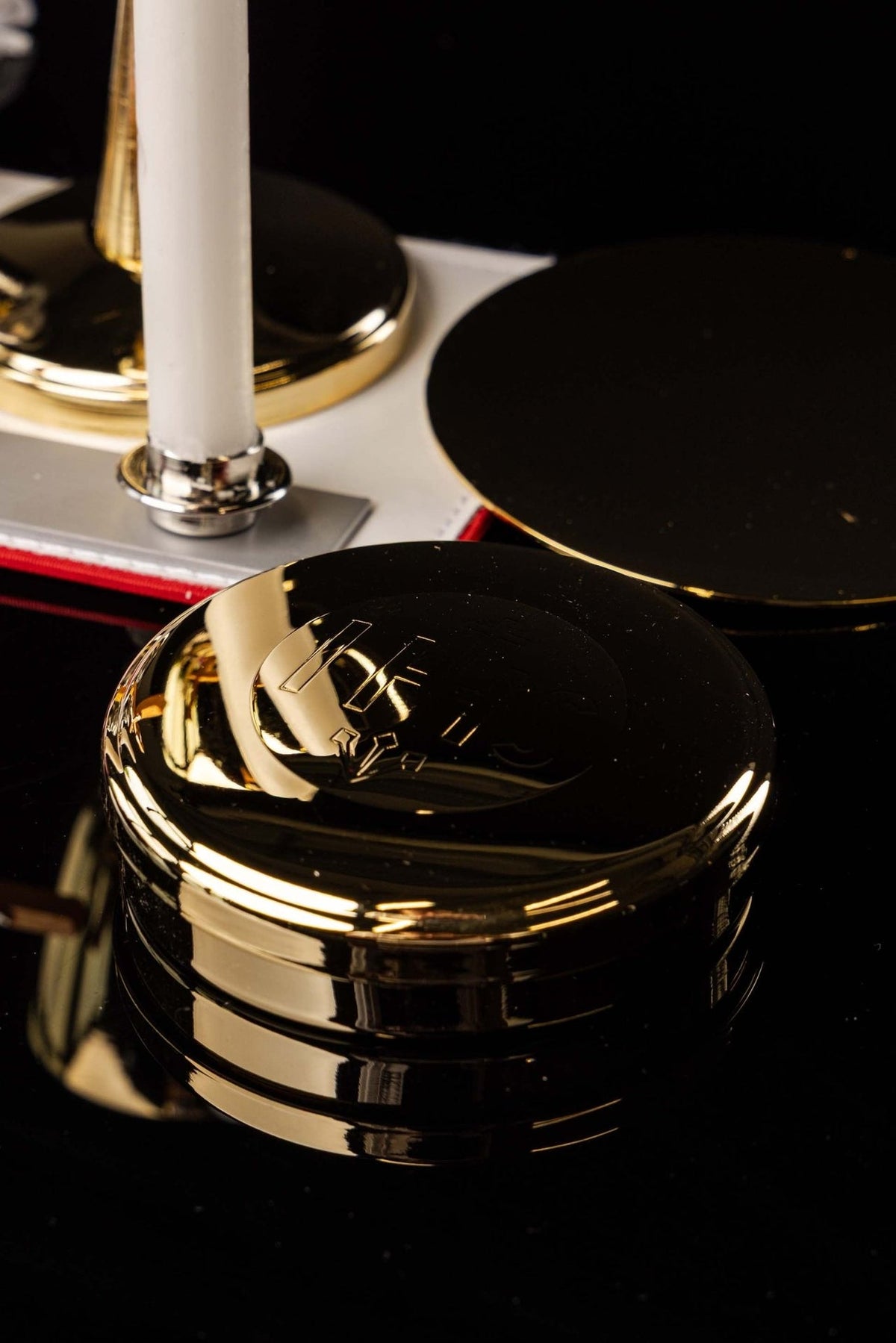 Mission suitcase close-up of round black and gold-edged covered vessels