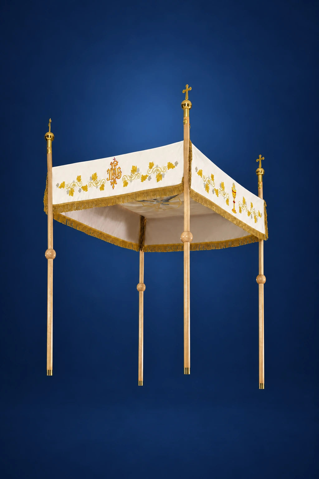 Ecru Corpus Christi canopy, three-quarter view, with gold embroidered floral trim and four tassel-topped poles