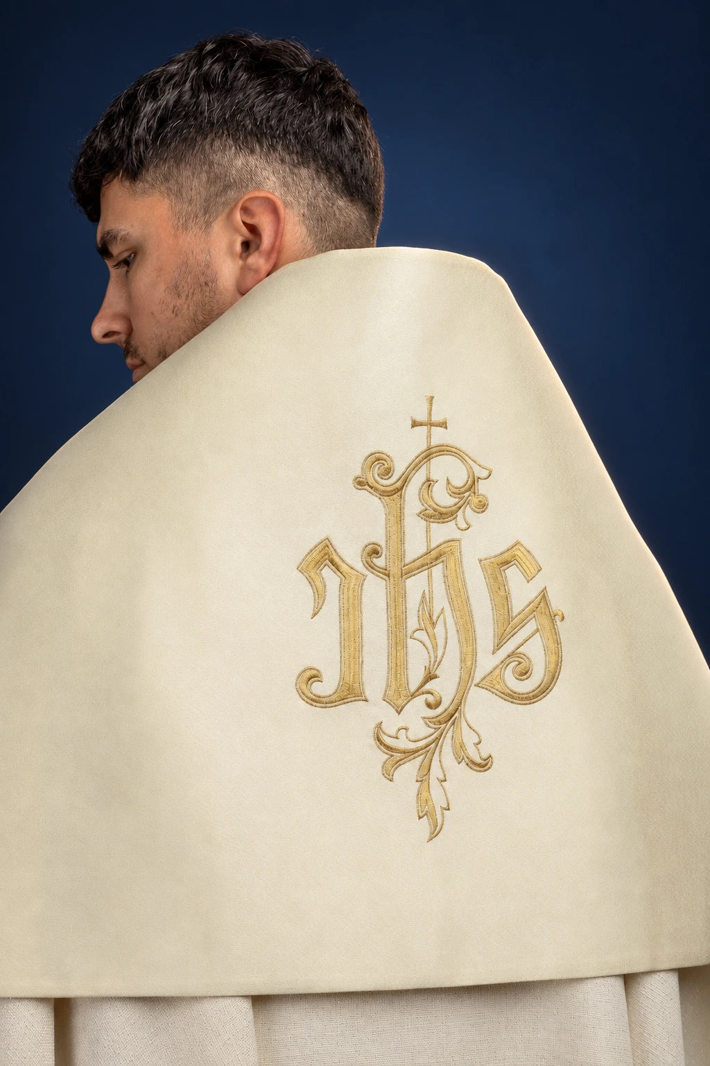 Ecru humeral veil, back view, with ornate gold monogram cross embroidery on the center panel