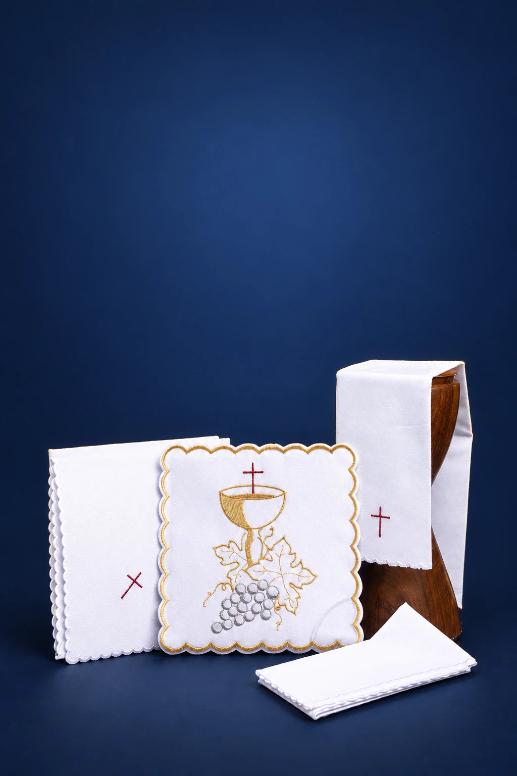 Embroidered altar linen set with chalice and grape motif, shown with folded purificator and veil pieces