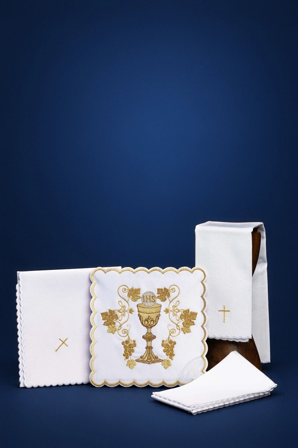 Embroidered altar linen set with chalice motif, including a frontal pall, purificator, corporal, and folded cloths