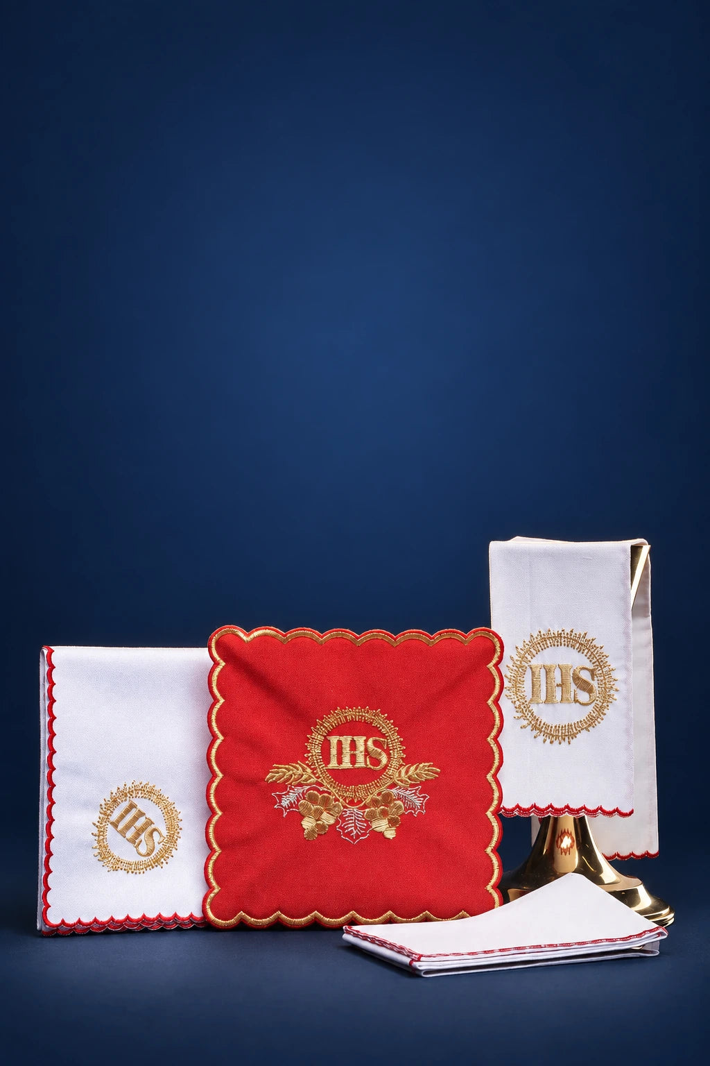 Embroidered altar linen set with red IHS corporal, two white linens, and matching folded purificators