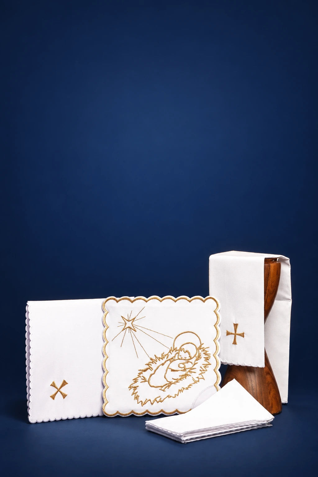 Embroidered Christmas altar linen set with star and manger motif, shown folded and arranged in front view