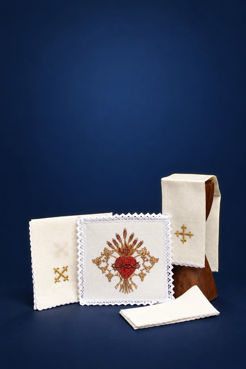 Embroidered linen altar linen set with Sacred Heart motif, shown folded with lace trim and cross embroidery