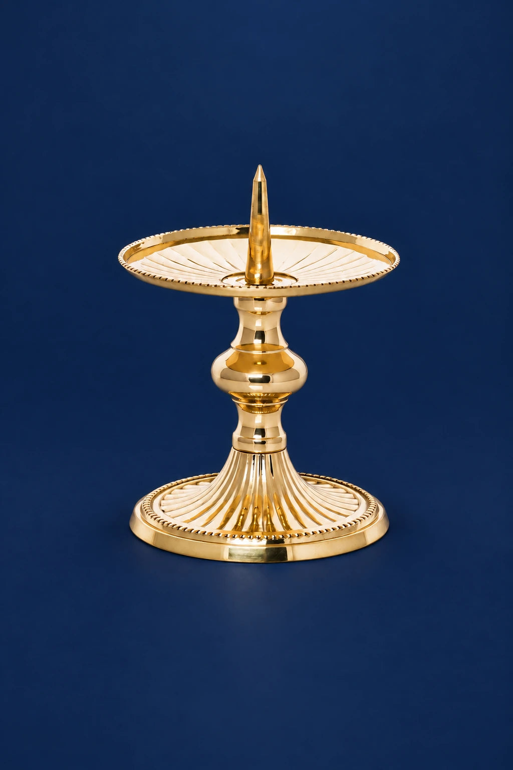 Brass Candlestick, 3.25 in (8.5 cm) High, front view with fluted plates and pedestal base