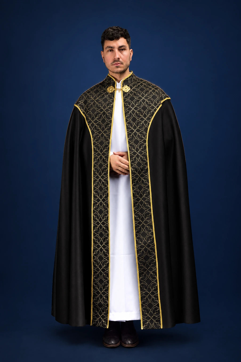 Front view of a black cope with gold trim and ornate embroidered jacquard yoke and front bands