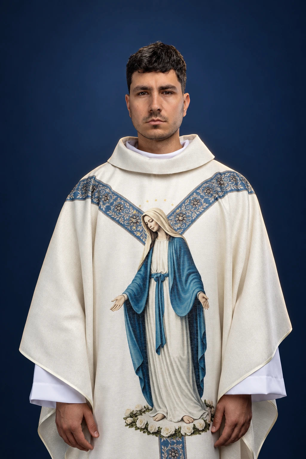 Front view of a cream chasuble with blue floral orphreys and a printed Our Lady of the Immaculate Conception image.