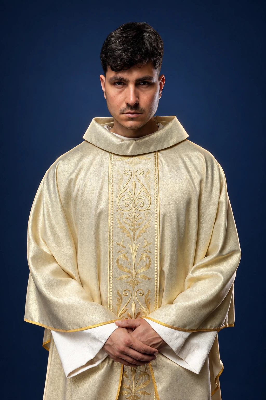 Front view of a cream chasuble with embroidered gold orphrey and gold trim