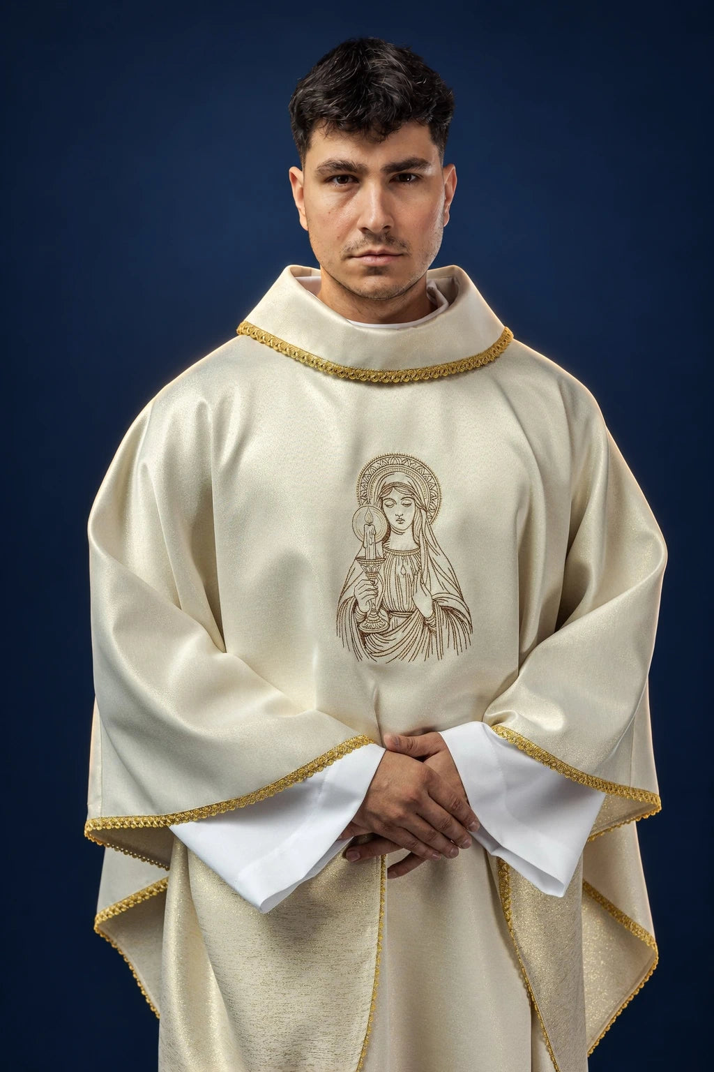 Front view of a cream chasuble with gold trim and embroidered Our Lady of Candlemas motif on the chest