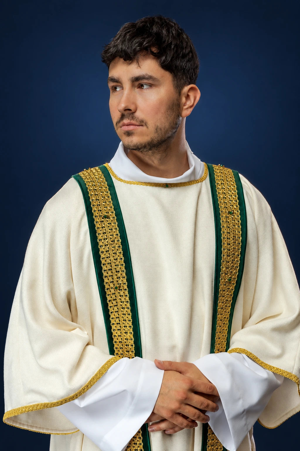 Front view of a cream dalmatic with green and gold woven vertical bands and gold-trimmed sleeves