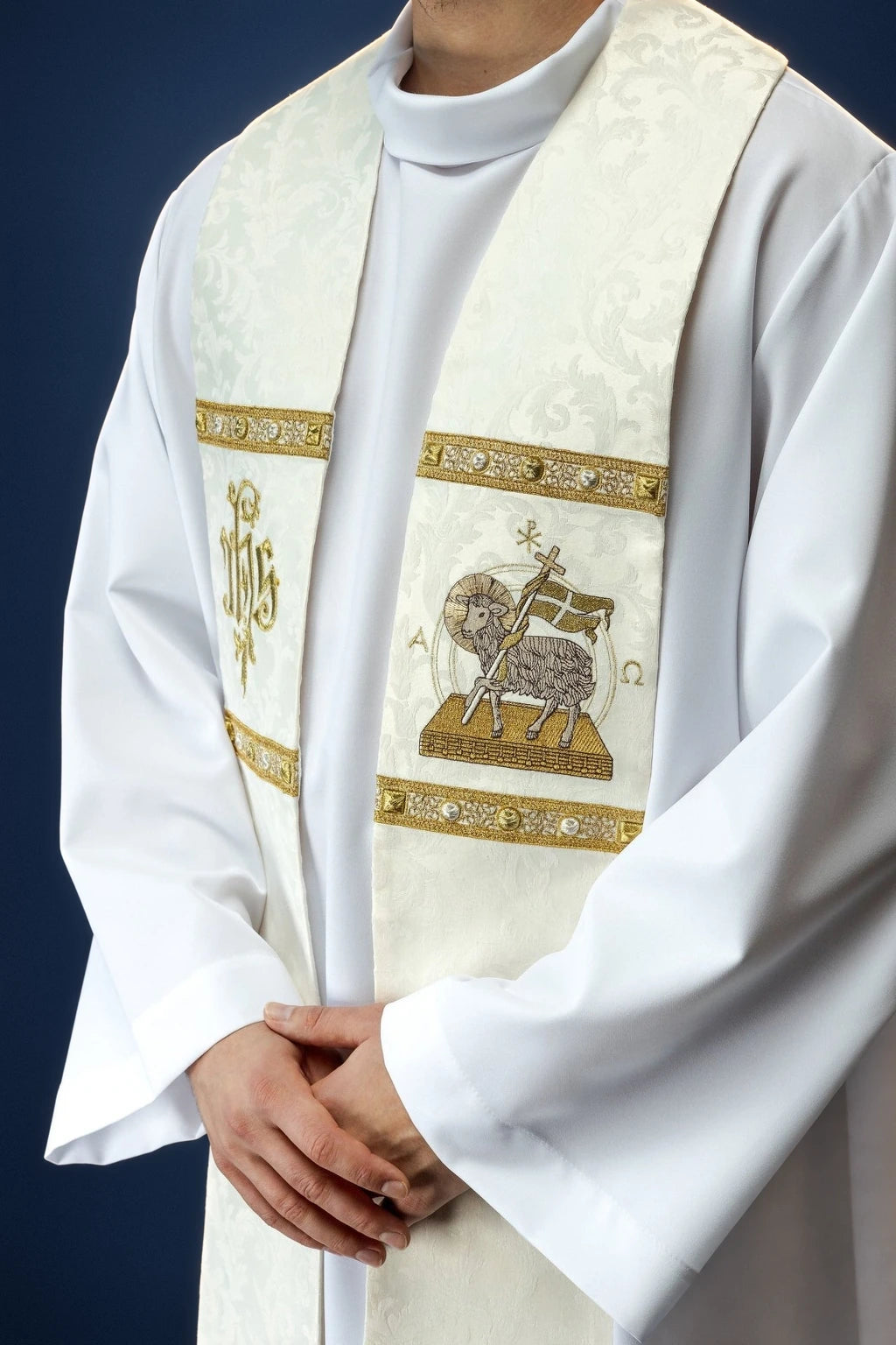 Front view of a cream stole with gold trim and Paschal Lamb embroidery