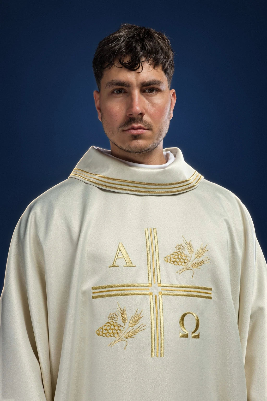 Front view of an ecru chasuble with embroidered cross, Alpha and Omega, and wheat motifs on the chest