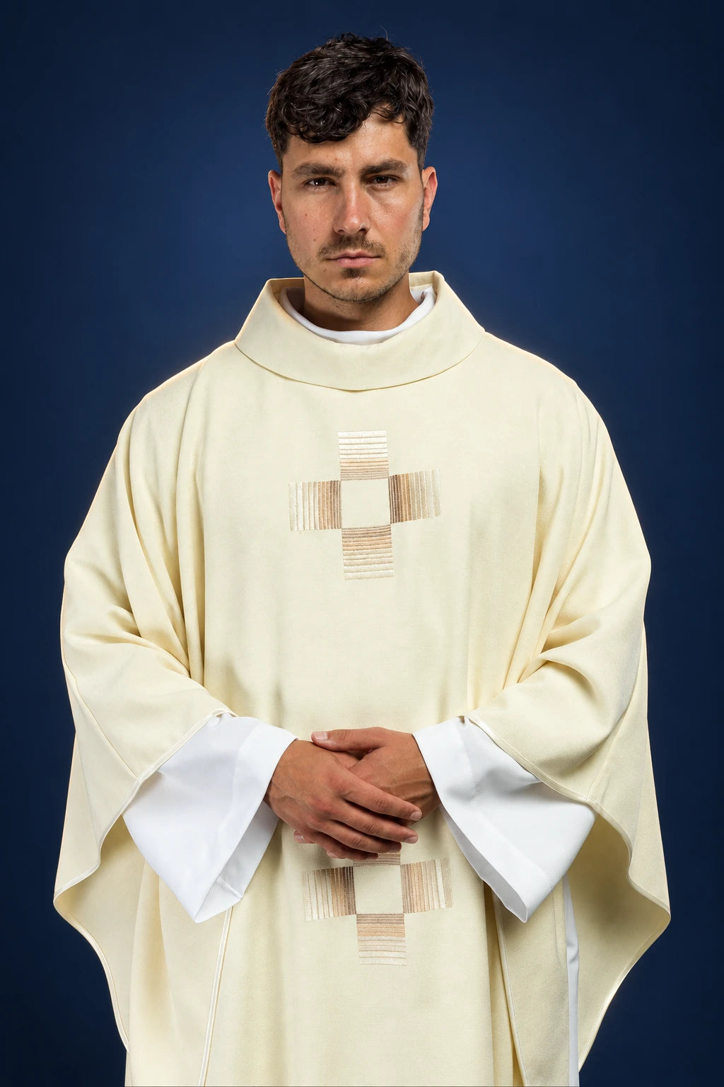 Front view of an ecru chasuble with embroidered cross motifs and wide sleeves