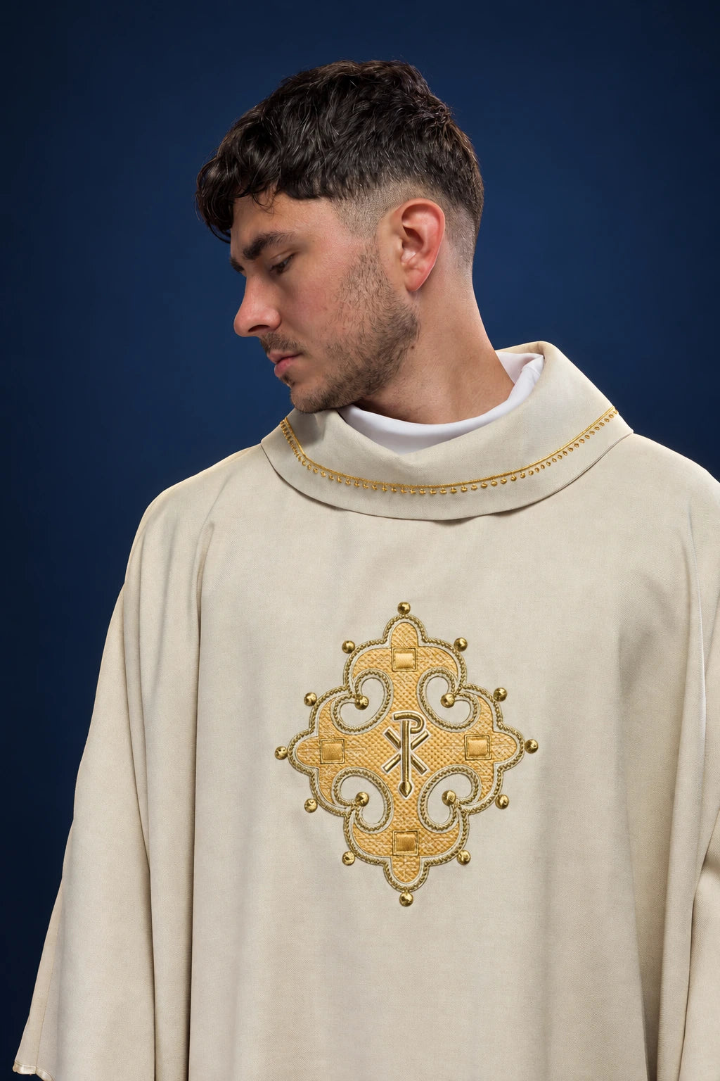 Front view of an ecru chasuble with embroidered gold cross and gold-trimmed collar