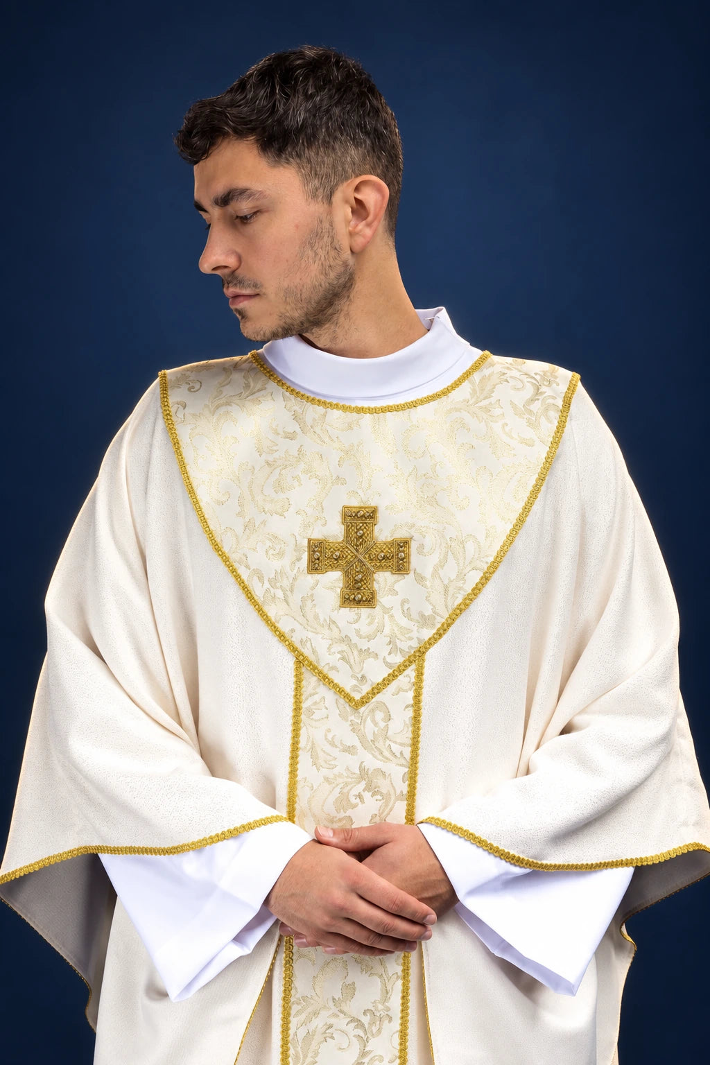 Front view of an ecru chasuble with gold cross and jacquard orphrey trim
