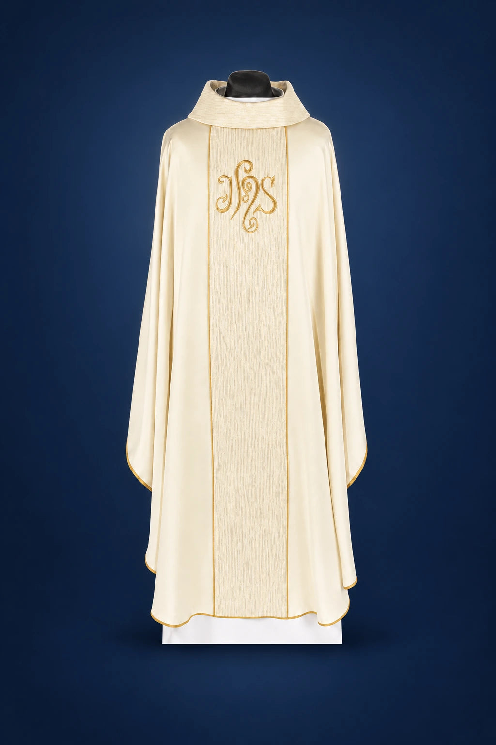 Front view of an ecru chasuble with gold-edged orphrey and IHS embroidery on the chest