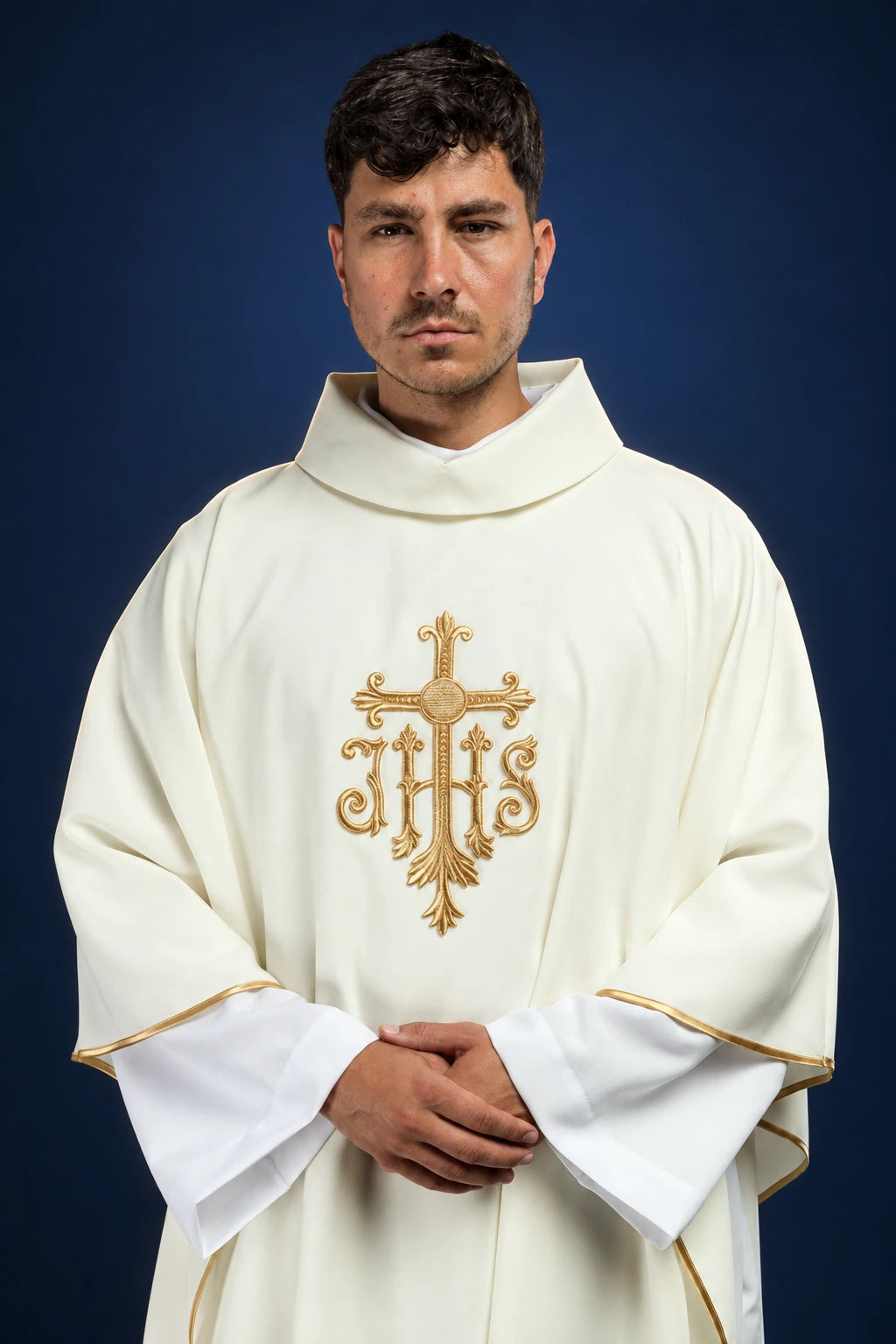Front view of an ecru chasuble with gold embroidered cross and IHS monogram
