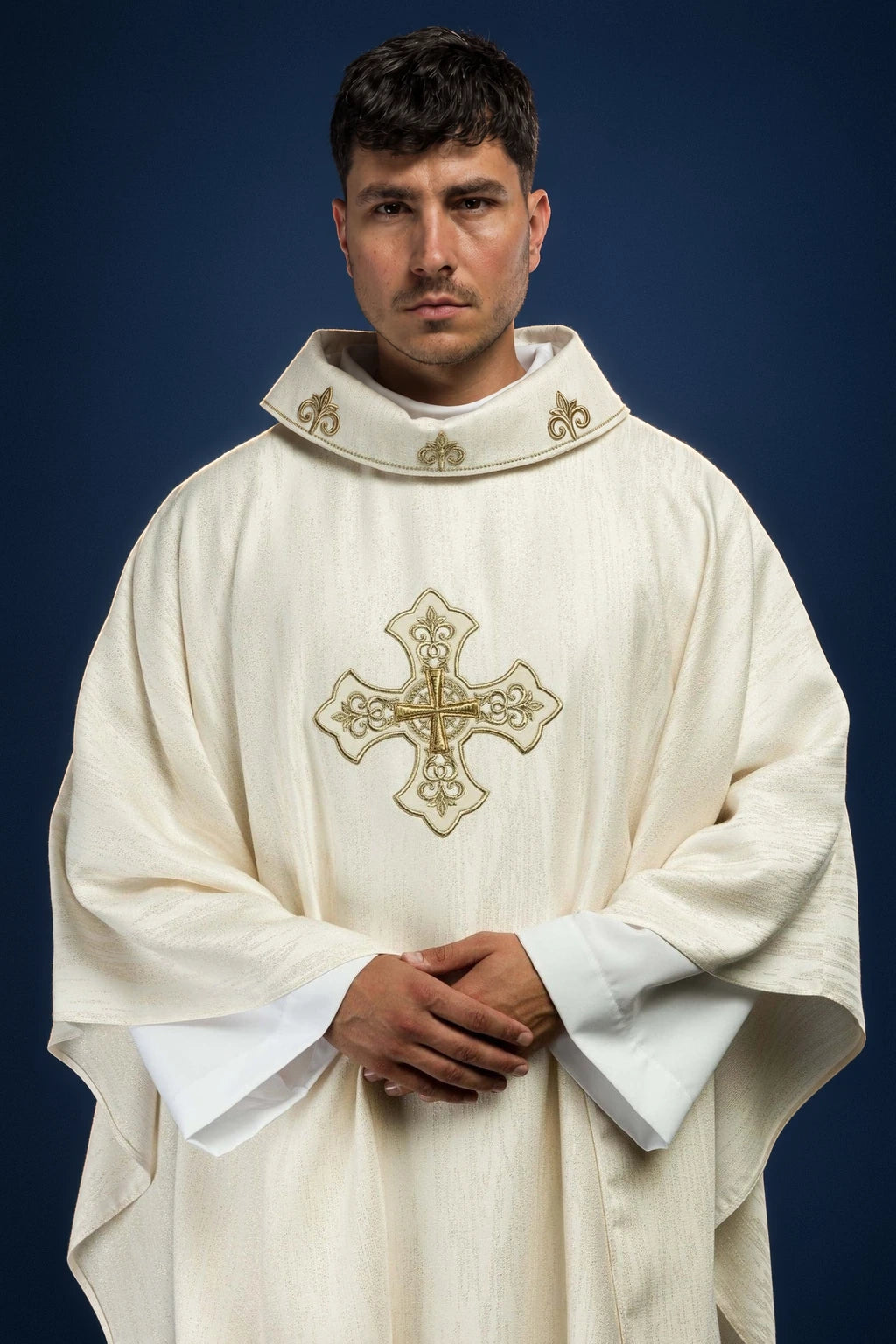 Front view of an ecru chasuble with gold embroidered cross motif and matching collar trim