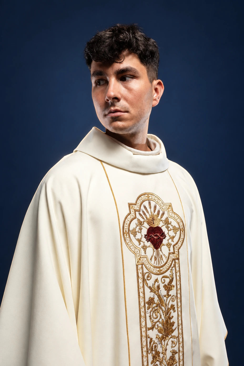 Front view of an ecru chasuble with gold embroidery and Sacred Heart chest panel