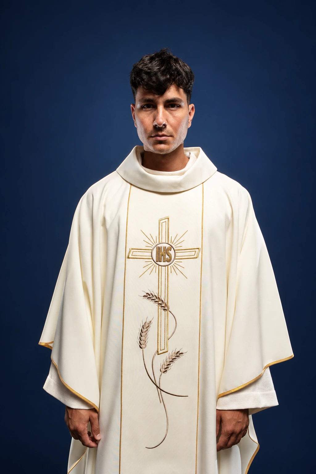Front view of an ecru chasuble with gold trim and central cross, IHS emblem, and wheat embroidery