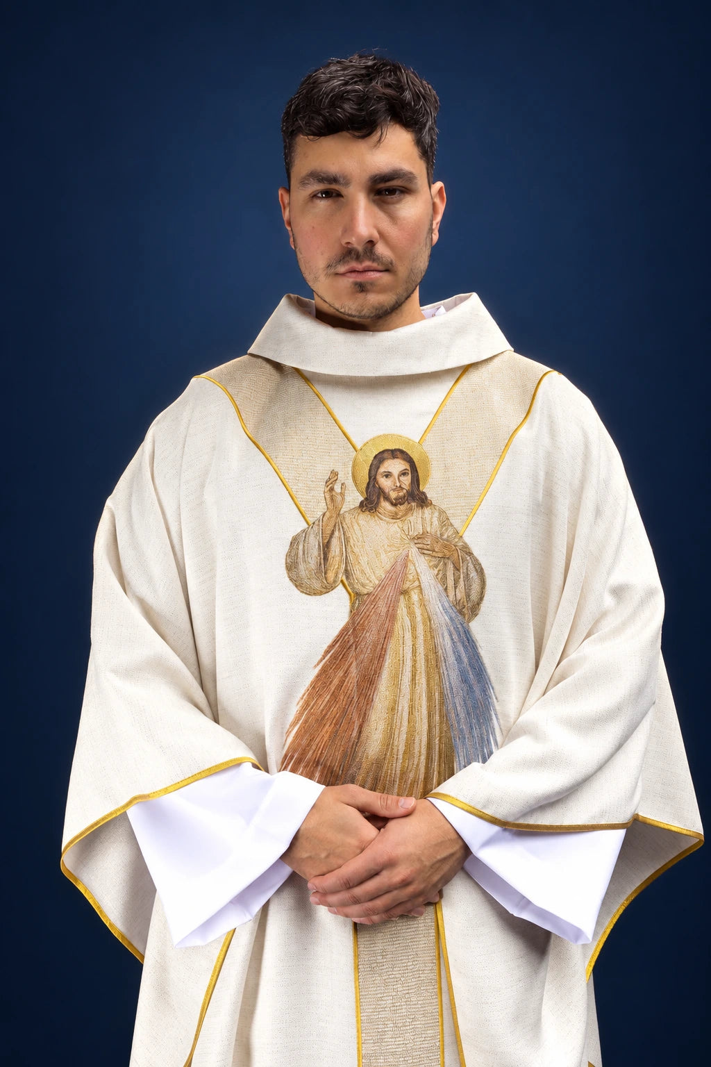 Front view of an ecru chasuble with gold trim and embroidered Divine Mercy image on the chest