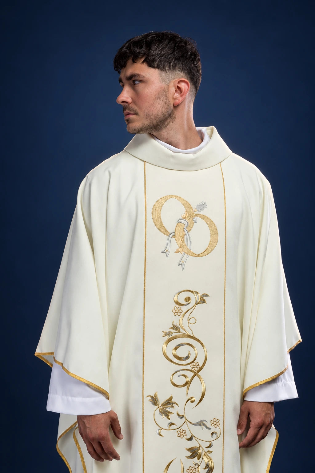 Front view of an ecru chasuble with gold wedding rings and vine embroidery on the front panel