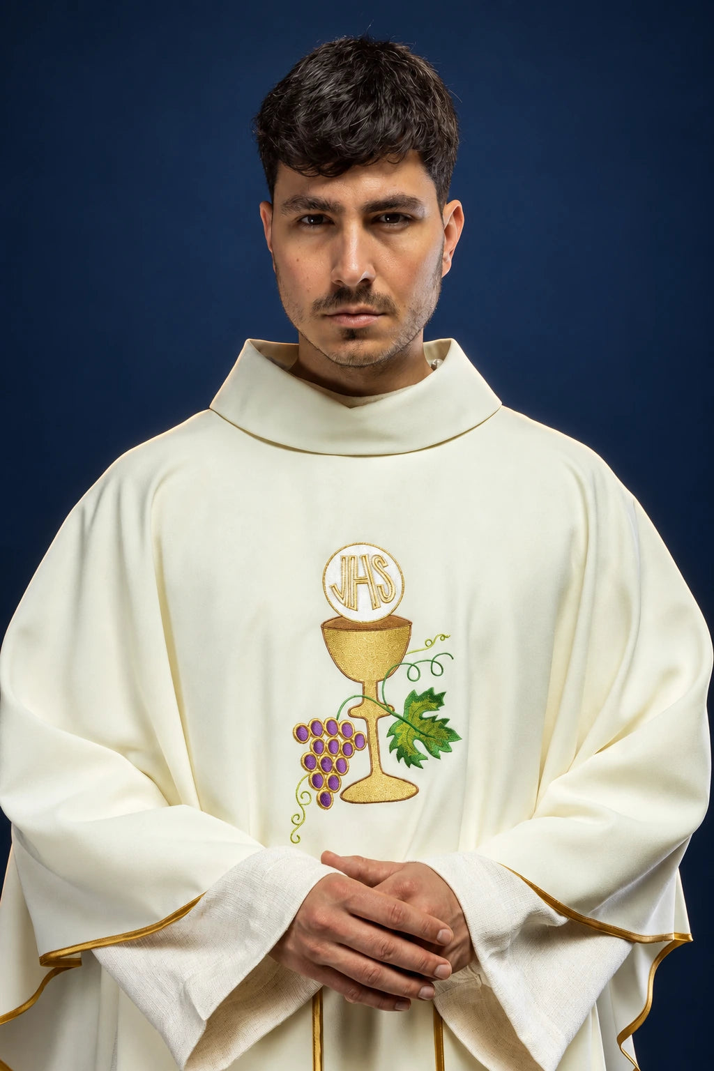 Front view of an ecru chasuble with IHS chalice, grapes, and gold trim