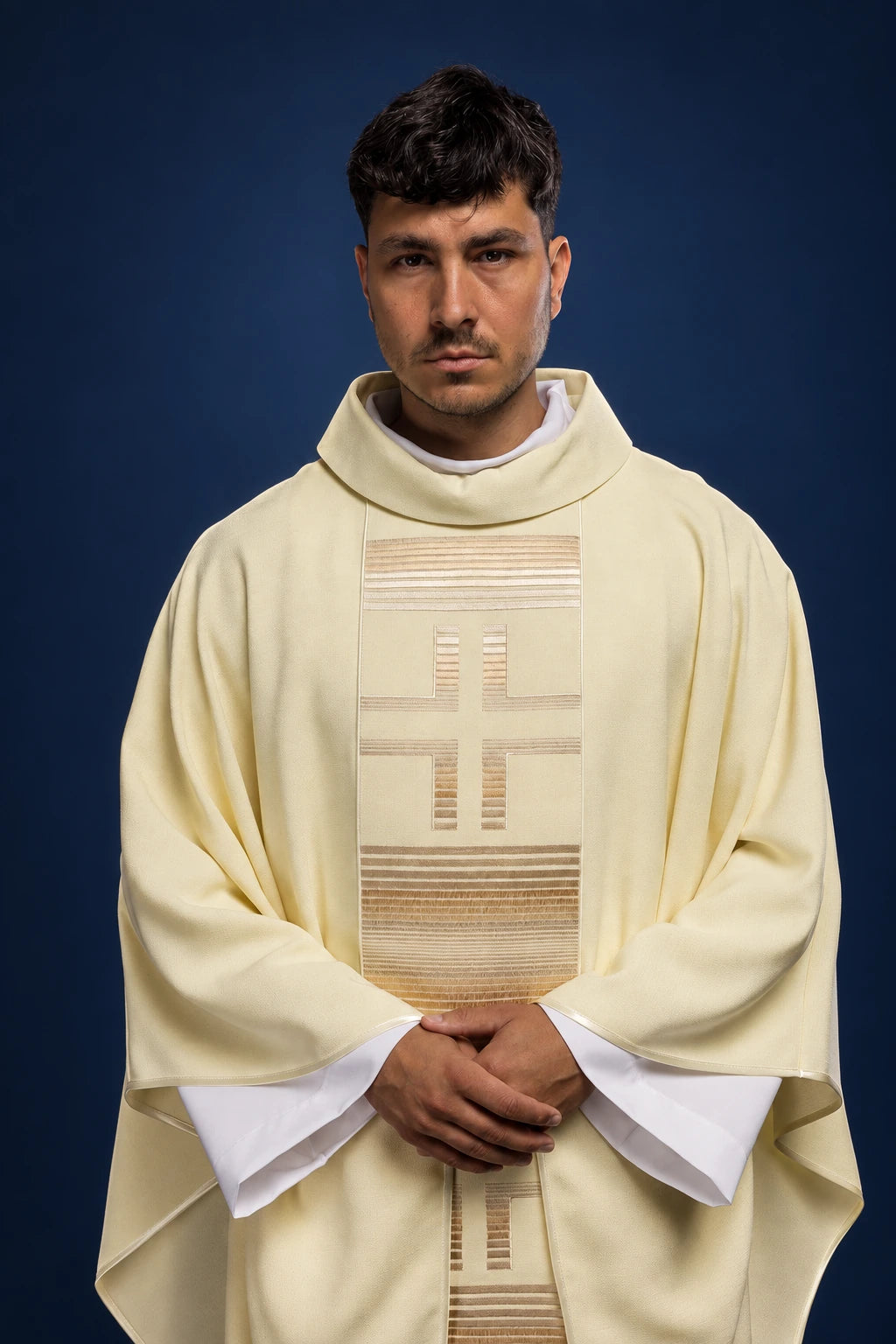 Front view of an ecru chasuble with vertical embroidered cross panel and narrow cross detail at the hem